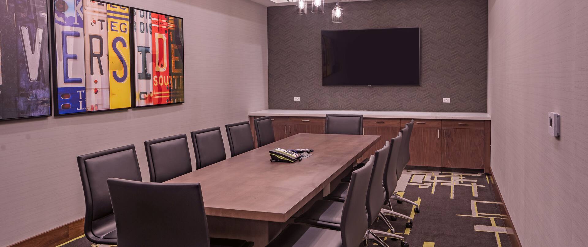 Boardroom with Meeting Table, Chairs and Wall Mounted TV