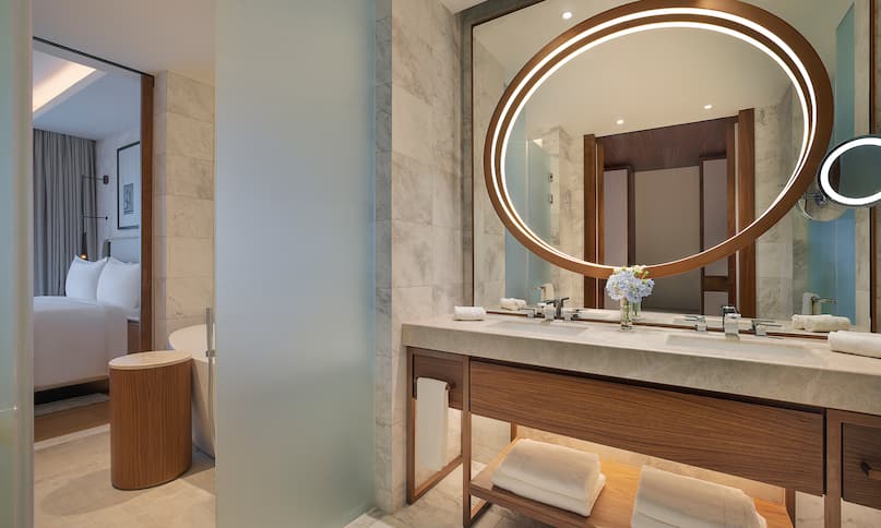 Dual Vanity Area with Round Lit Mirror in a Hotel Suite-previous-transition