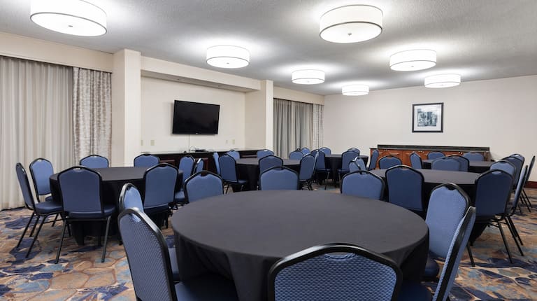 Catawba Meeting Room Setup with Blue Round Tables and HDTV