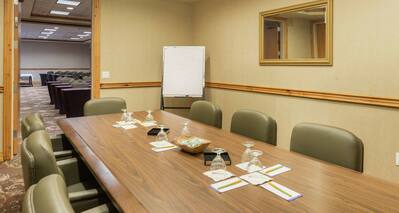 Seating for 8, Presentation Easel, and Open Doorway  in Boardroom