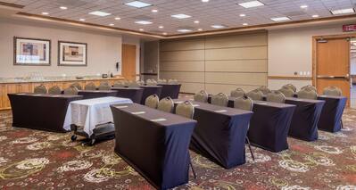 Classroom Setup in Meeting Room With Tables, Chairs, and Entry