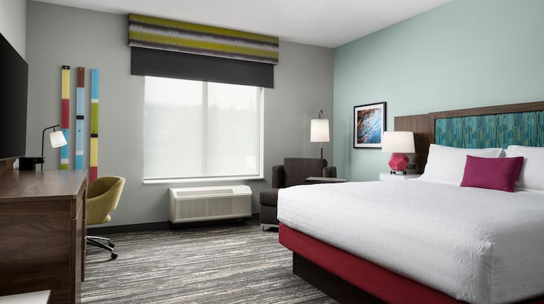 King Guest Room with HDTV and Armchair