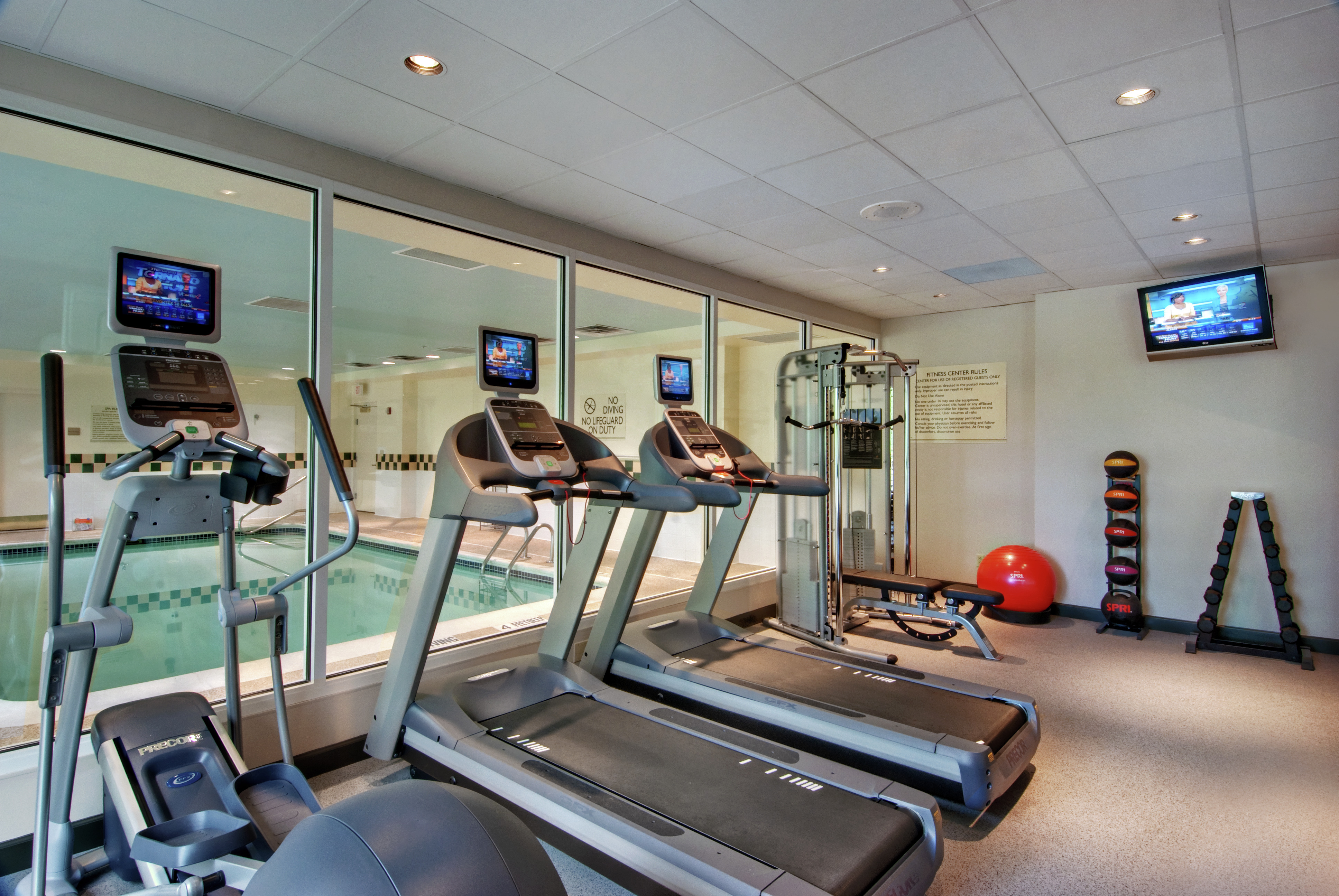 Fitness Center with View of Swimming Pool 