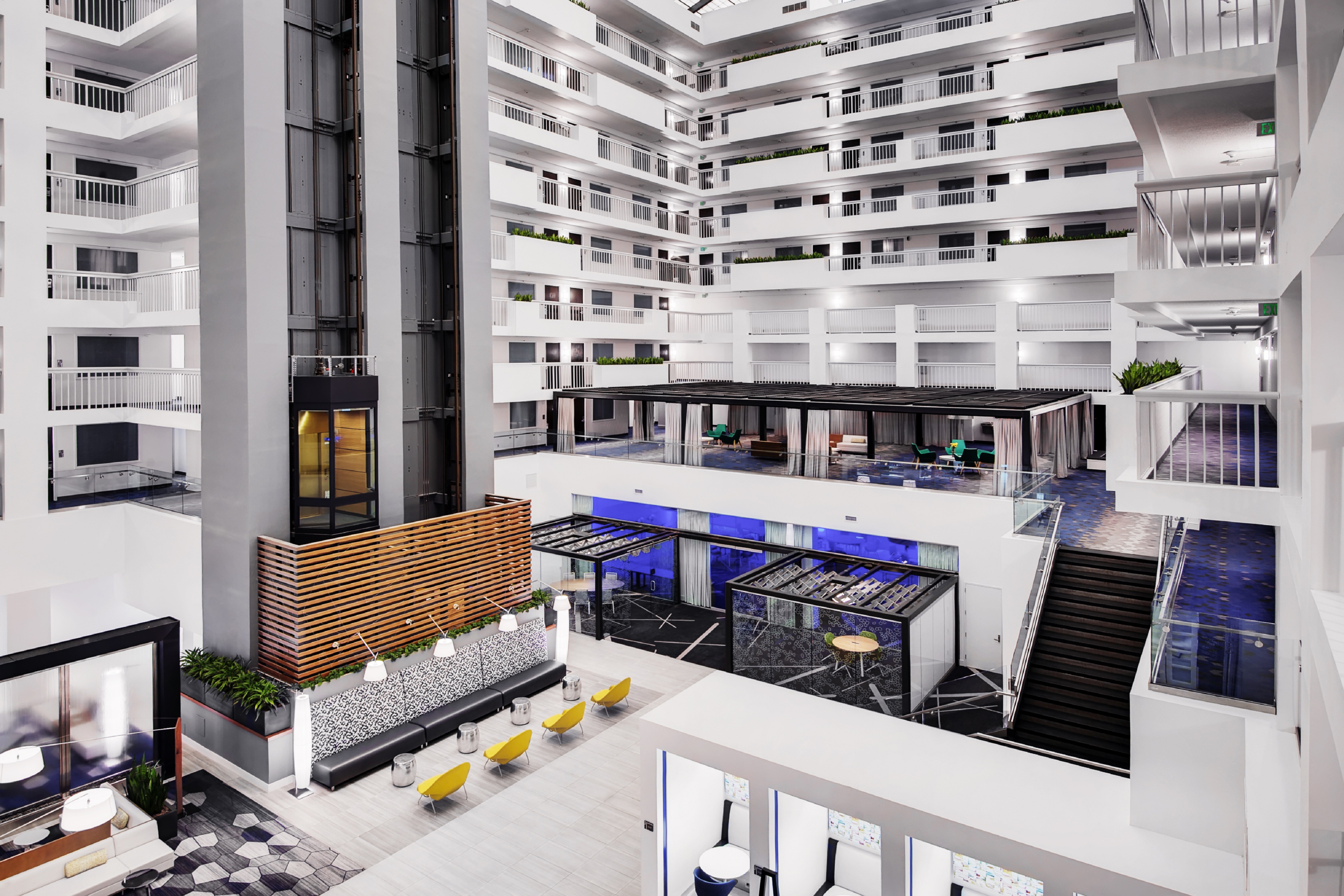 View of Atrium Showing Seating Area, Elevator, Stairs, and Guest Room Balconies