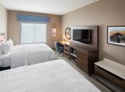 Guest Room with Two Beds Desk and HDTV