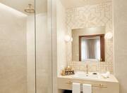 Premier Suite Bathroom with Vanity, Mirror and Shower with Glass Door