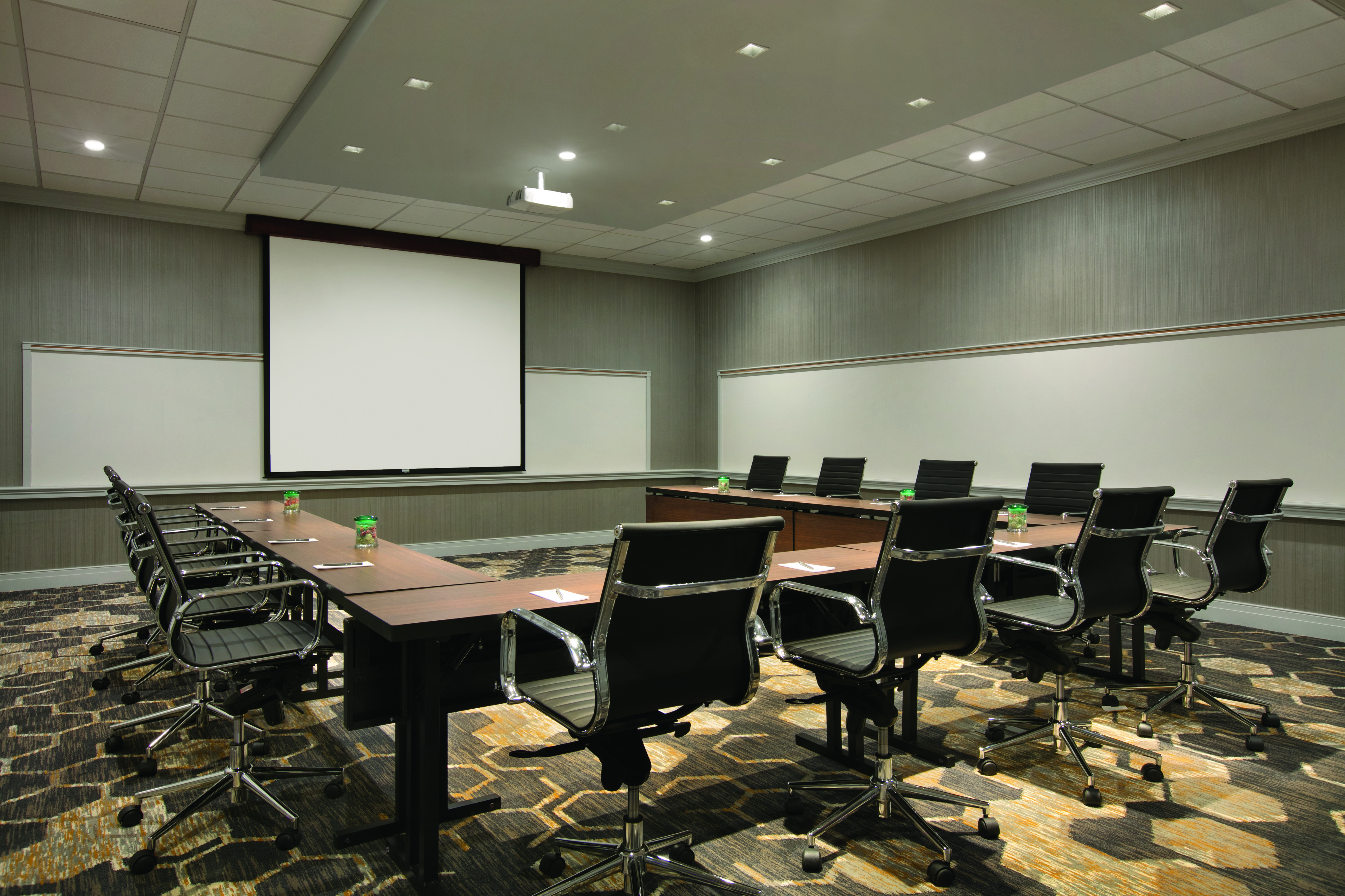 Meeting room with tables, chairs and projector