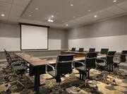 Meeting room with tables, chairs and projector
