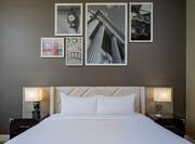 King Guestroom Executive Floor with bed, lamps and wall art above bed.