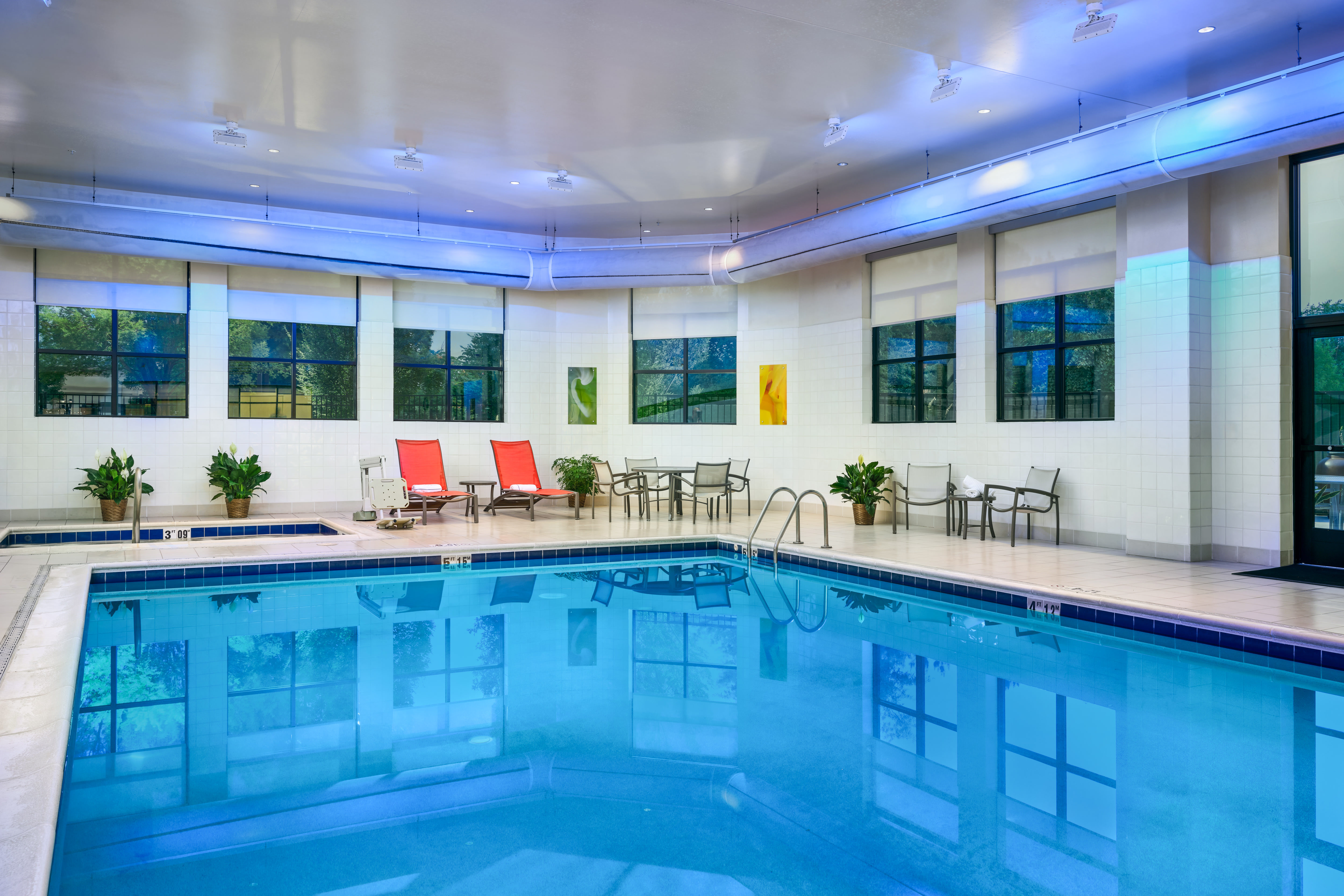 indoor pool, hot tub, lounge chairs, tables
