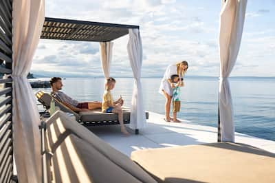 Family relaxing by water