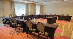 Meeting Room With Bottled Water on U-Shaped Table, Chairs, and Projector Table