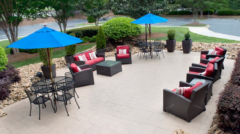 Tables With Umbrellas, and Soft Seating on Patio by Parking Lot
