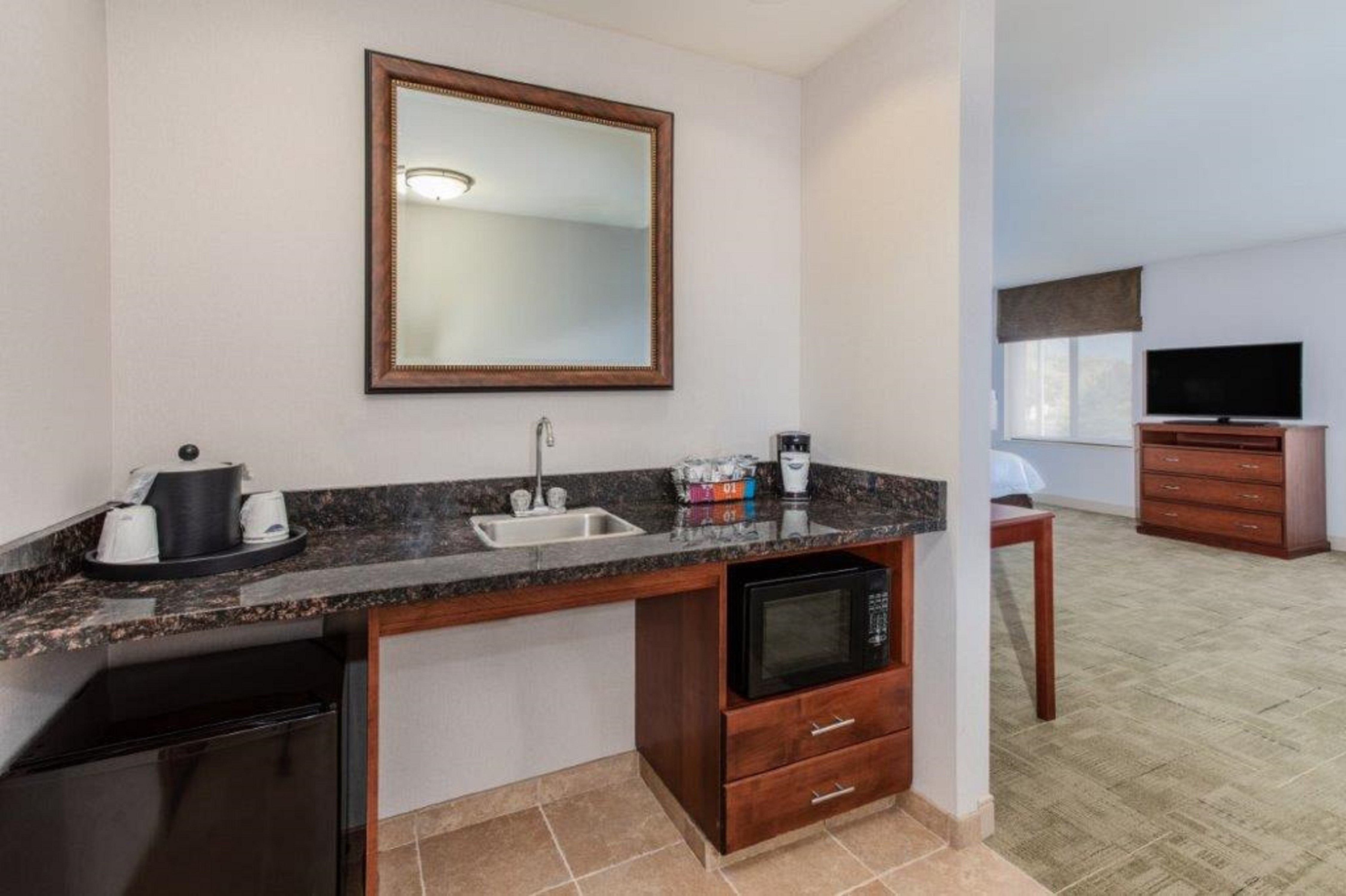 Suite wetbar area with sink and mirror