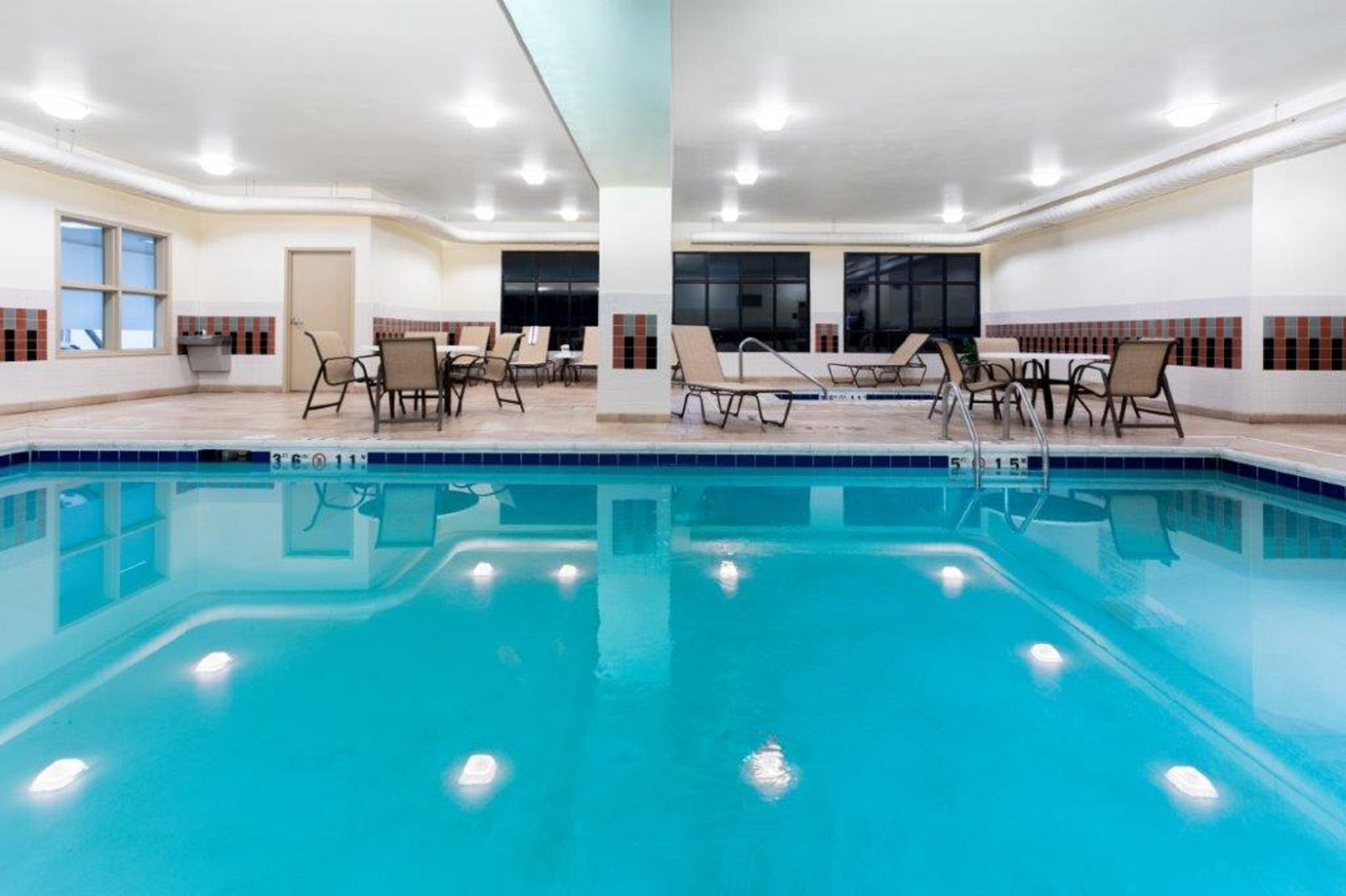 Indoor pool with tables and chairs