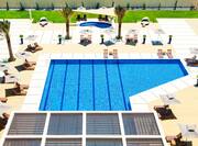 Aerial View of Outdoor Pool and Lounge Seating ona Sunny Day