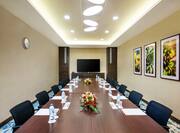 Seating for 12 atTable in Al Khor Meeting Room With TV and Wall Art