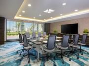 Seating for 10 at Square Boardroom Table Facing Large TV in Al Nakheel Meeting Room