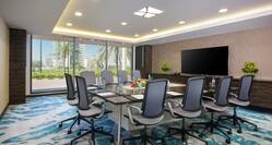 Seating for 10 at Square Boardroom Table Facing Large TV in Al Nakheel Meeting Room
