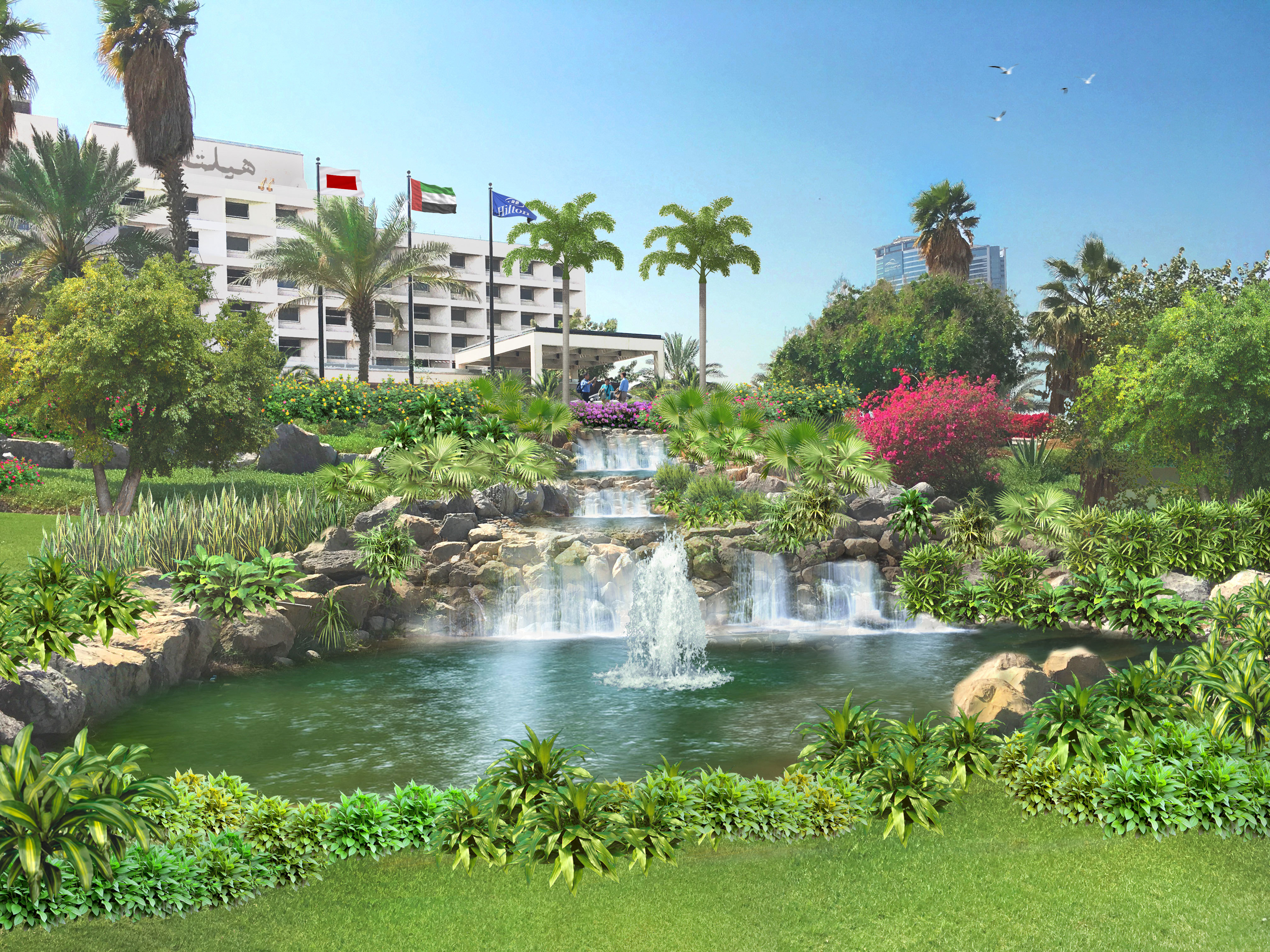 Daytime View of Hotel Exterior, Flag Poles, Fountains, and Garden
