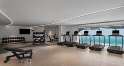 Fitness Center with Modern Equipment and Large Windows with Sea View