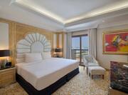 Large Bed in Suite with HDTV Seating Area and Balcony