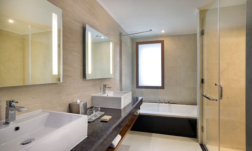 Dual Vanity Area Bathtub and Glassdoor Shower in Hotel Suite-previous-transition