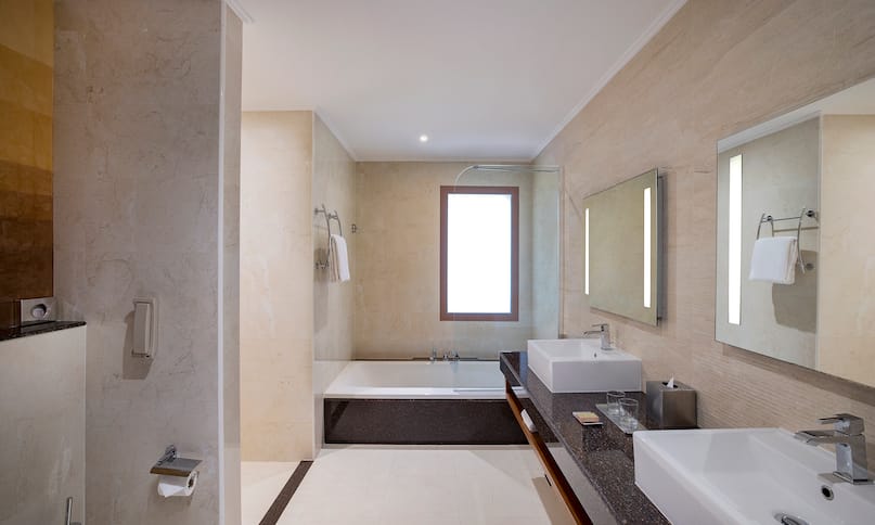 Junior Suite Bathroom with Dual Vanity Area and a Bathtub-previous-transition