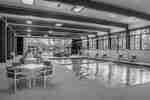 Indoor Pool Area with Tables and Chairs