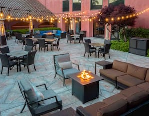 outdoor patio lounge area, fire pit, string lights