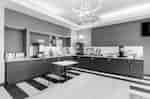 Breakfast buffet area with serving counters, tables, and beverage stations.