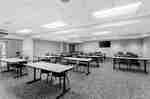 Meeting and event space arranged with tables, chairs, and presentation areas.