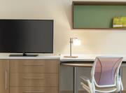 Convenient in-room work station featuring TV, work desk, and ergonomic chair.
