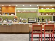 Bright breakfast area featuring complimentary daily buffet stocked with delicious food and beverages.