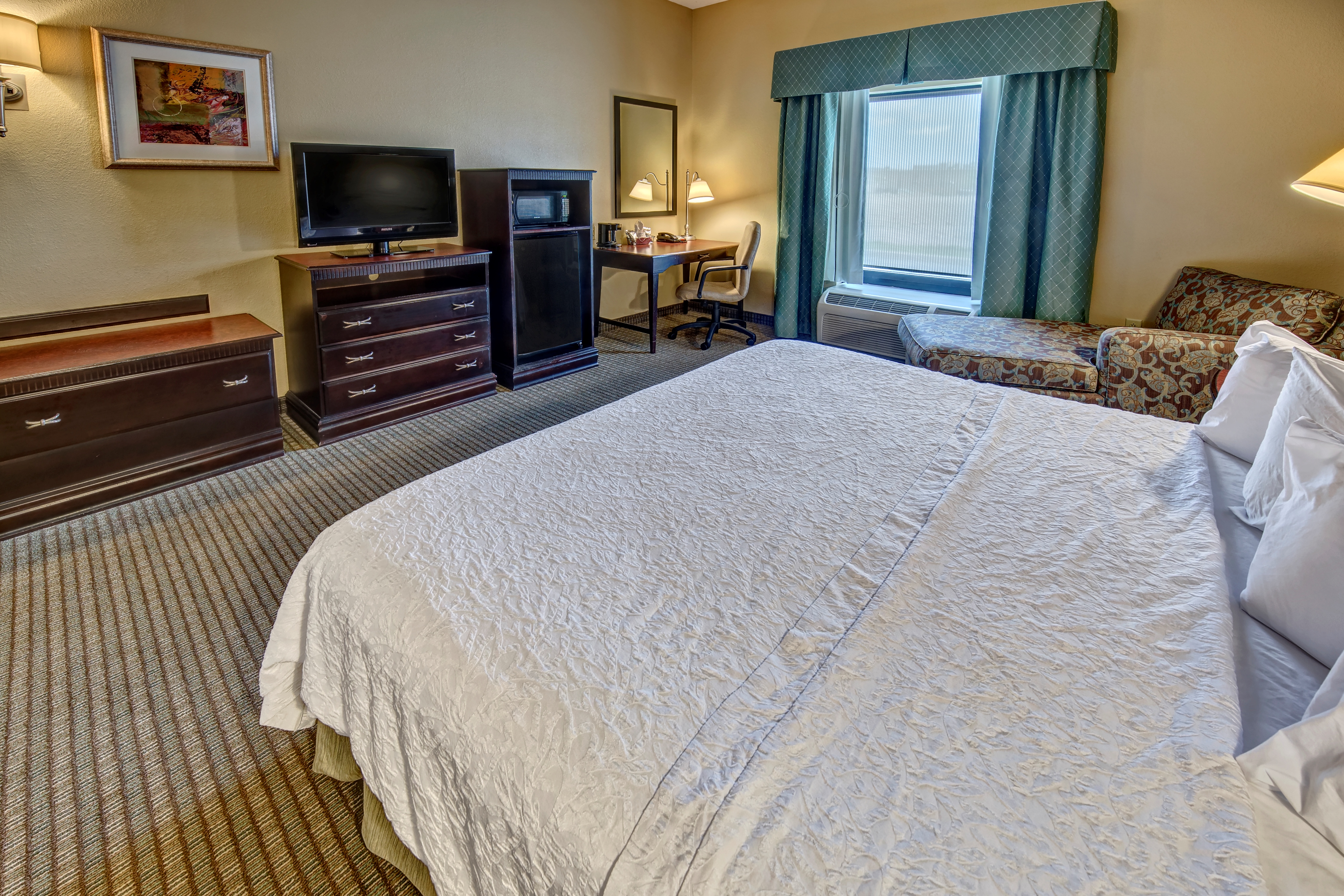 King Bed, Soft Chair and Amenities in Accessible Room