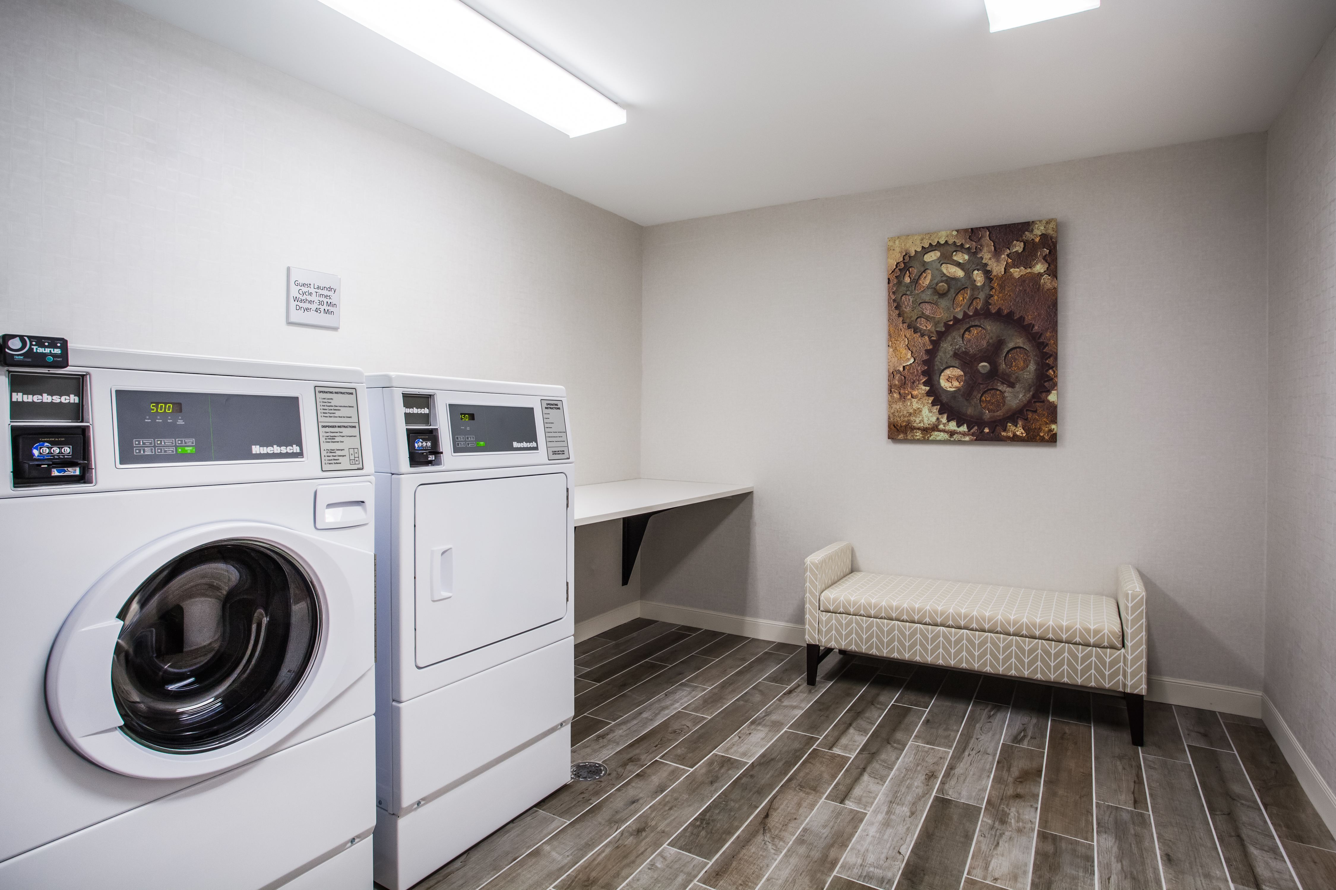 Guest Laundry Room with Washing Equipment and Bench