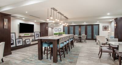 Lobby Seating Area with Tall Table, Tall Chairs and Wall Mounted HDTV