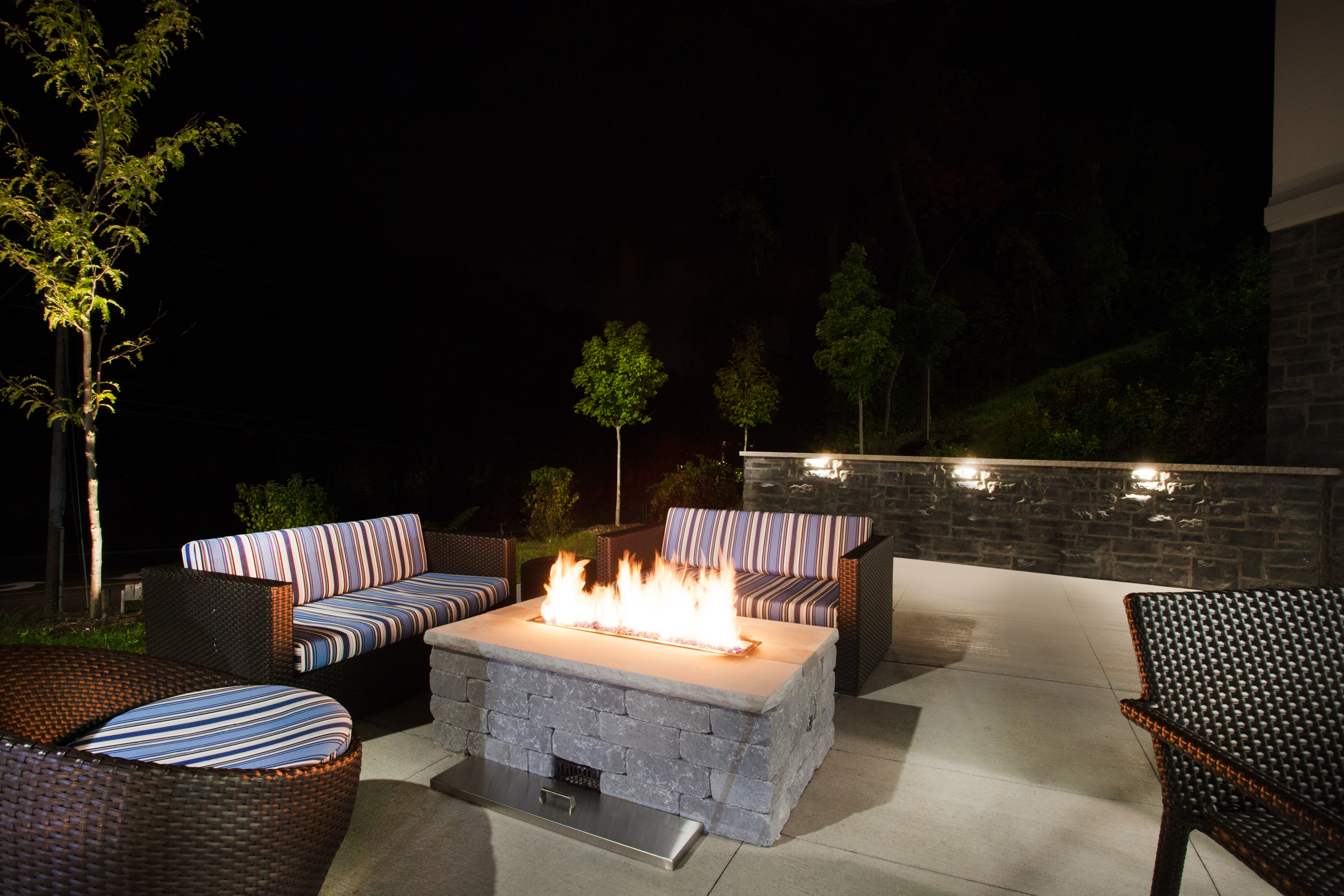 Outdoor Patio Seating Area with Fire Pit at Night