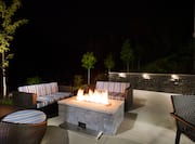 Outdoor Patio Seating Area with Fire Pit at Night