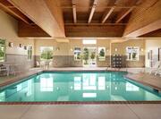 Beautiful indoor pool featuring large windows, cedar ceiling, and ample seating.