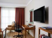 Guest Suite with Work Desk, Wall Mounted HDTV, Armchair and Coffee Table