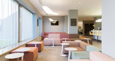 Lobby Seating Area with Soft Seats and Small Circular Tables