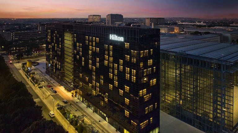 Hilton Hotel Exterior in a City at Sunset