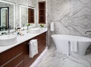 Suite Bathroom with Dual Vanity and Bathtub
