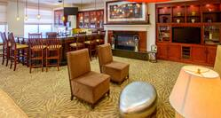 Lobby Bar Lounge with Bar Stools, Armchairs, Fireplace and HDTV