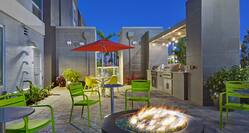 outdoor patio with firepits and barbeques at dusk