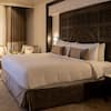 King-size bed with bedside tables, armchairs and coffee table in Junior Suite