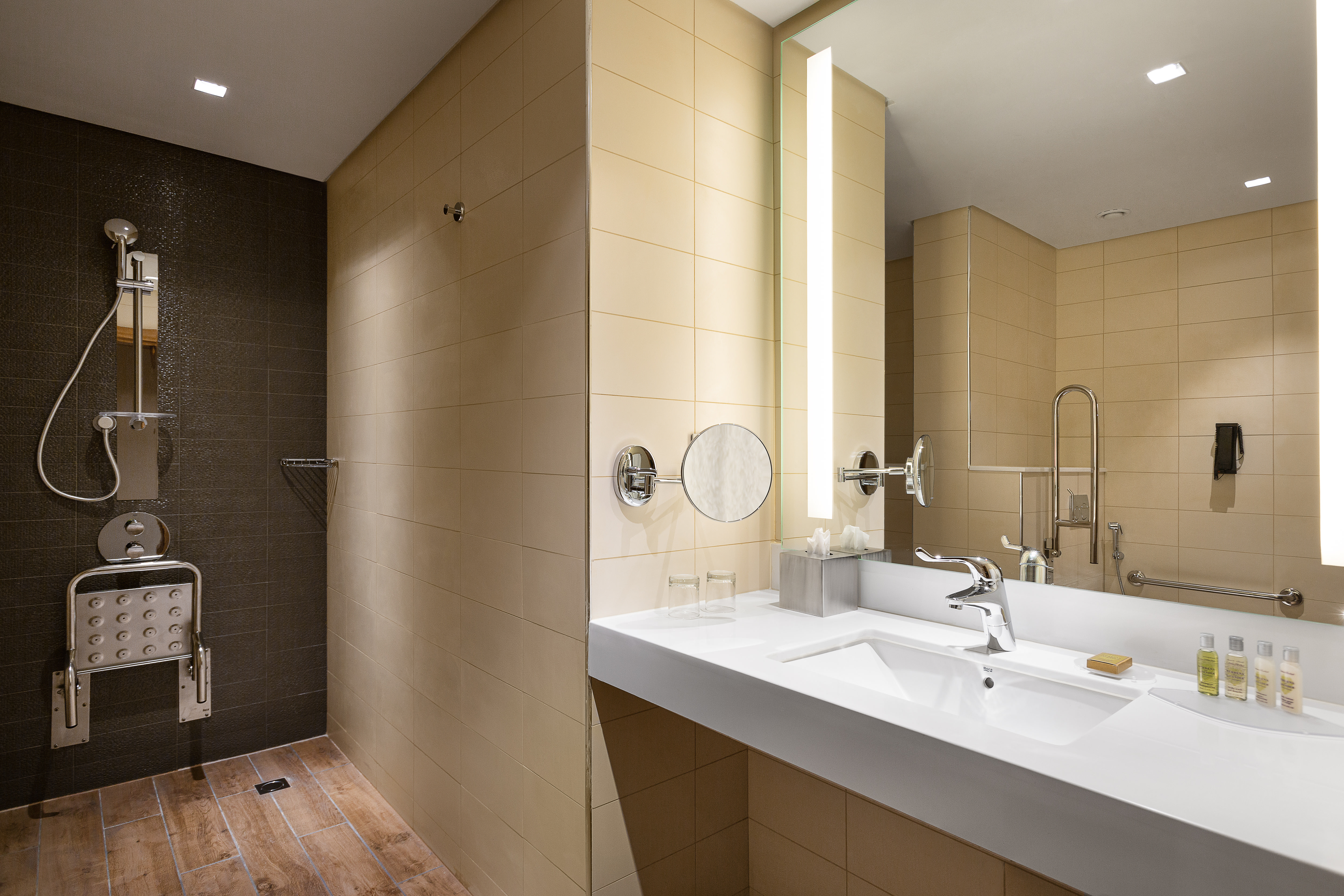 Accessible bathroom with roll-in shower and seat which can be stored away