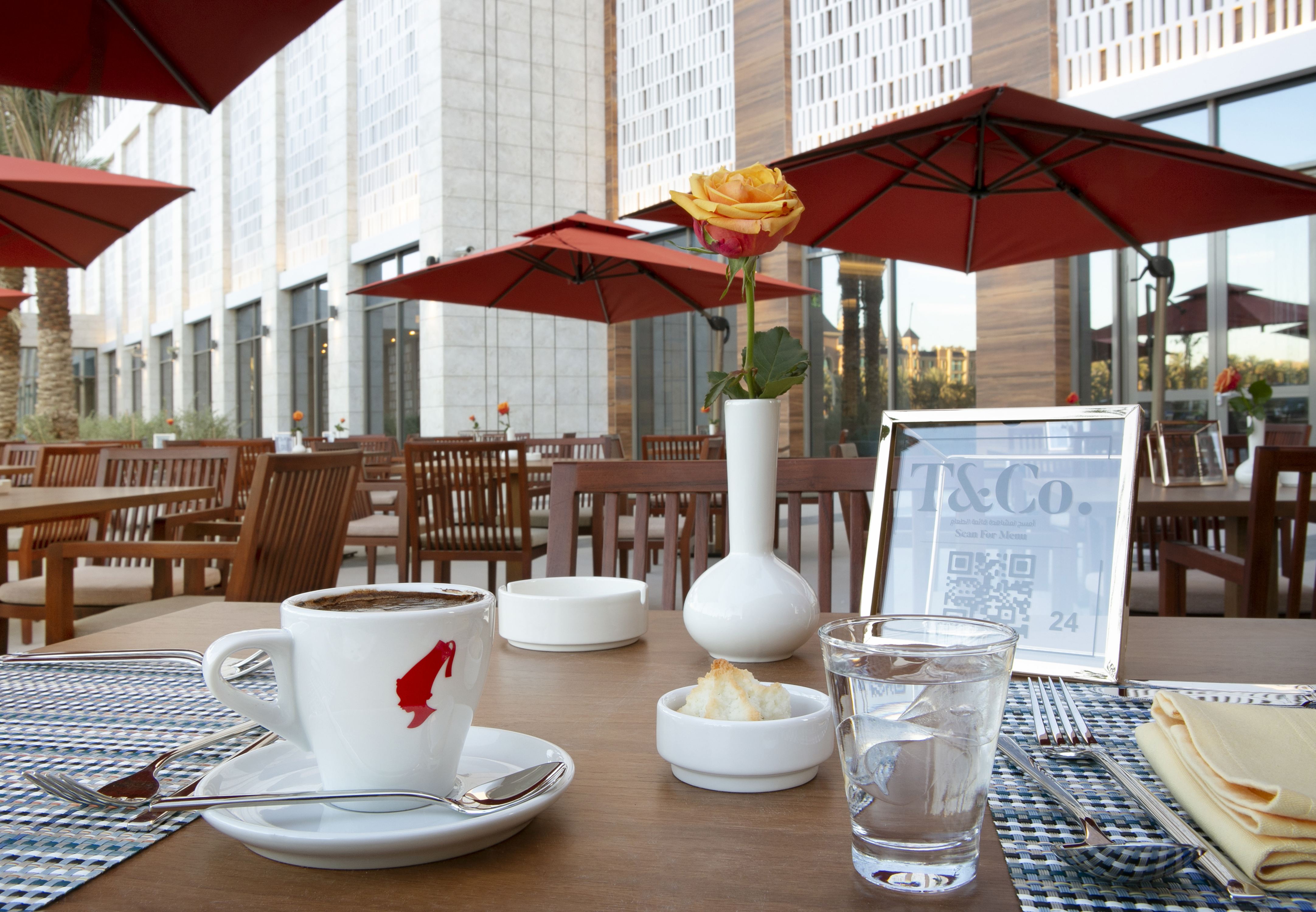 Outdoor seating tables with close up of coffee and cup of water