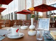 Outdoor seating tables with close up of coffee and cup of water